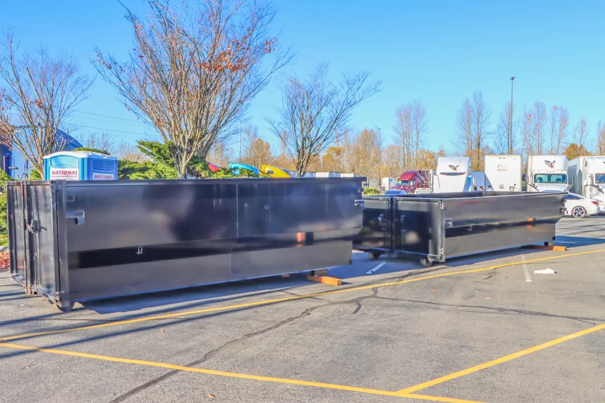 Professional dumpster rental service with roll-off container on residential driveway in Manitowoc